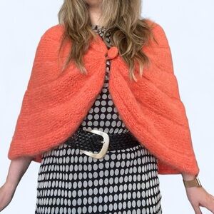 Orange knitted wool cape with button detail
One Size
